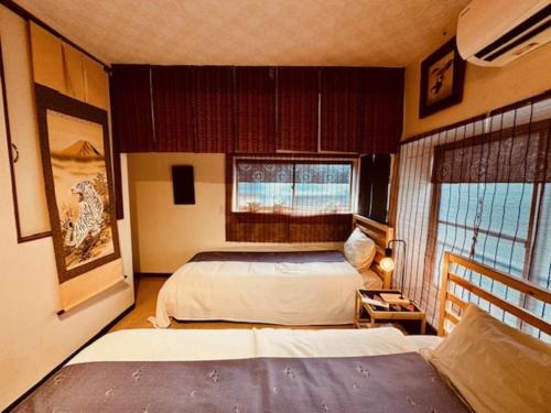 Postel nebo postele na pokoji v ubytování ViVo銀座