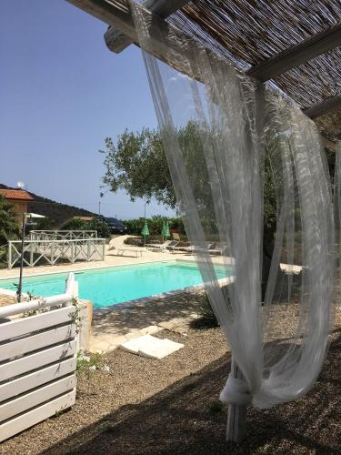 a pergola next to a swimming pool at Antica Tindari in Patti