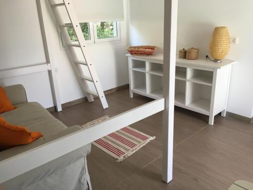 a living room with a ladder and a couch at Antica Tindari in Patti