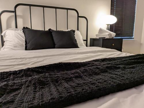 a black and white bed with a black blanket at Bishop Hostel in Dallas