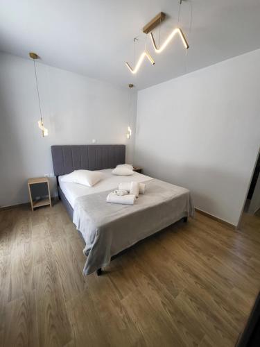 a bedroom with a bed with two towels on it at Diamond Piraeus Port in Piraeus