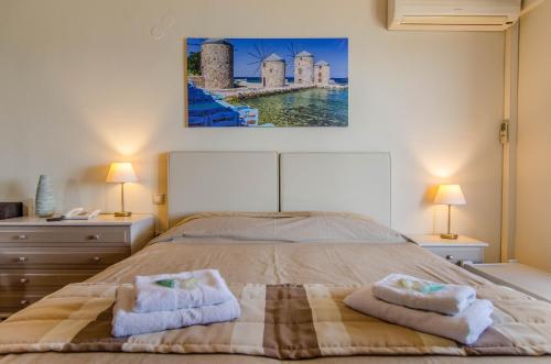 a bedroom with a bed with two towels on it at Plaka Studios in Karfas