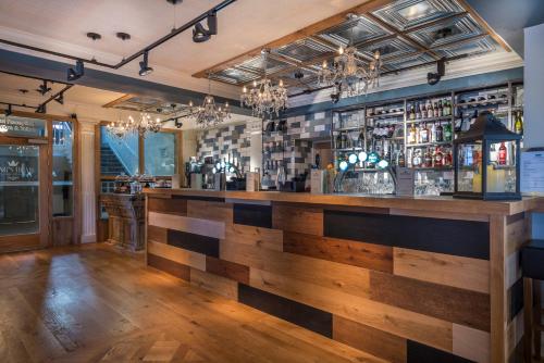 a bar in a restaurant with a wooden counter top at The Kings Head Hotel, Richmond, North Yorkshire - The Coaching Inn Group in Richmond