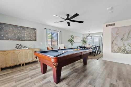 a living room with a pool table and a dining room at Summer Splash Pool, Spa & Game Room in Mesa