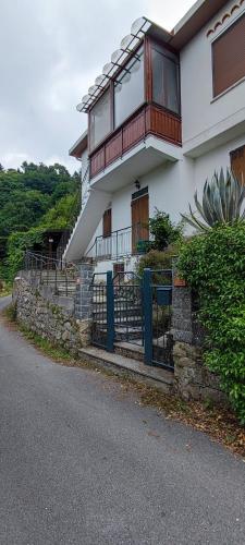 a house with a balcony on the side of the road at Rocca Fiorita - Bilocale con spazio esterno, parcheggio sotto casa in Baiardo