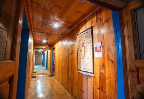 a hallway with wooden walls and a painting on the wall at Sherpa Panorama Hotels in Khumjung