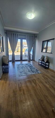 a large living room with a large window and a living room with a couch at Namaqua Bella Vista in Springbok