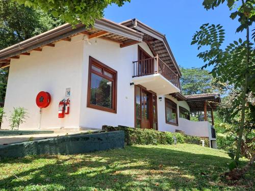 a small white house with a red fire hydrant at Mirage Kandyan Heights in Kandy