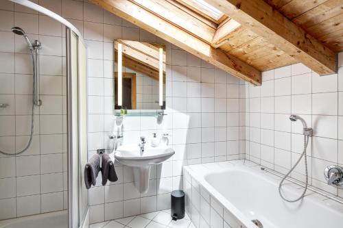 a bathroom with a sink and a tub and a shower at Haus Schönblick - wunderbare Zentrumslage in Alpbach
