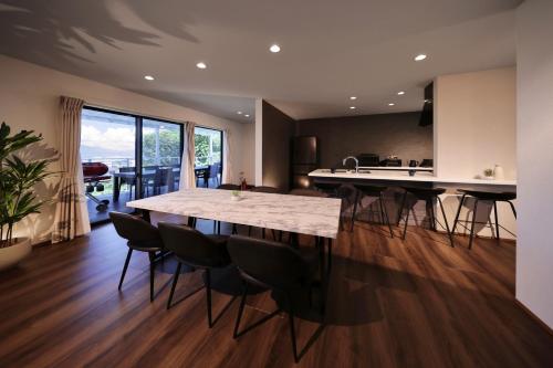 a kitchen and dining room with a large table and chairs at Crystal Besso Shirahama in Shirahama