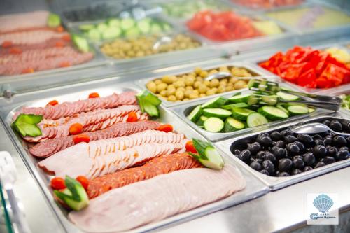 a display case with many different types of food at Hotel Carmen Azzuro in Venus
