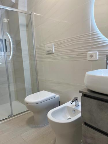 a bathroom with a shower and a toilet and a sink at Cuore di casa in Manfredonia