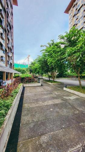 an empty street in a city with trees and buildings at Staycation at Eastbay in Manila