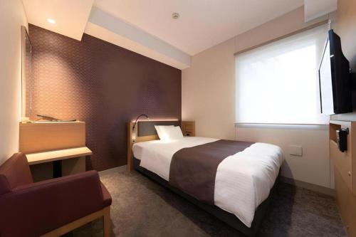 a hotel room with a bed and a window at KEIKYU EX INN Tokyo Nihombashi in Tokyo