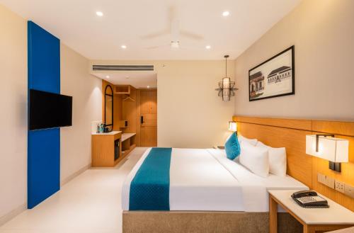 a hotel room with a bed and a desk at Effotel by Sayaji Panaji, Goa in Panaji