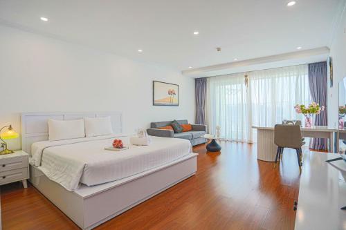 a bedroom with a large bed and a living room at La Casa Nha Trang - GoldCoast Tower, Yellow-Amber-Beach & Lotte Mall in Nha Trang