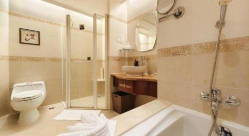a bathroom with a shower and a toilet and a sink at Quanzhou Hotel in Quanzhou