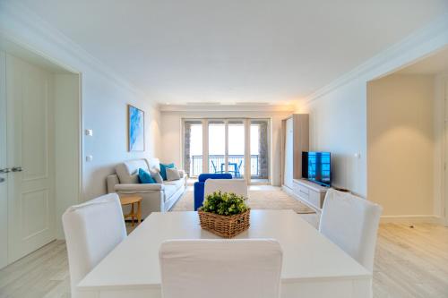a living room with a white table and chairs at Lustica Bay Marina Village by 2BHome in Lustica