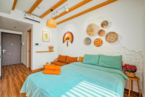 una camera da letto con un letto blu e un divano di MONday Première Aparts - Gold Coast Tower, Lotte Mall & 5-Min-To-Beach a Nha Trang
