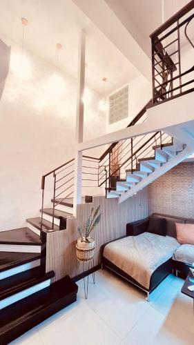 a bedroom with a loft bed and stairs at Super Cebu Loft in Cebu City