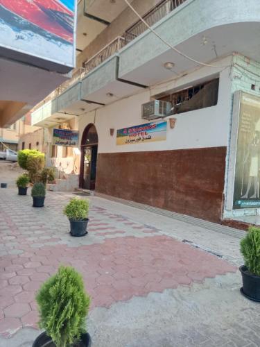 a building with potted plants sitting outside of it at Four Seasons Hotel in Hurghada