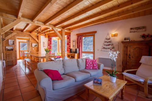 a living room with a couch and a table at Le Troll Hameau des Chazals Nevache Hautes Alpes in Névache