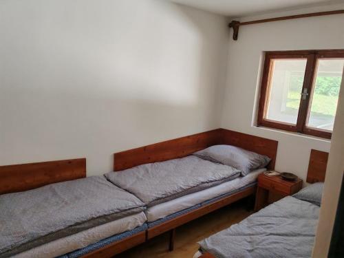 a bedroom with two beds and a window at Chata Limbach in Limbach