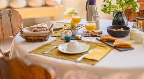 a white table with food and drinks on it at La chaumière du Tordoir in Les Rues-des-Vignes