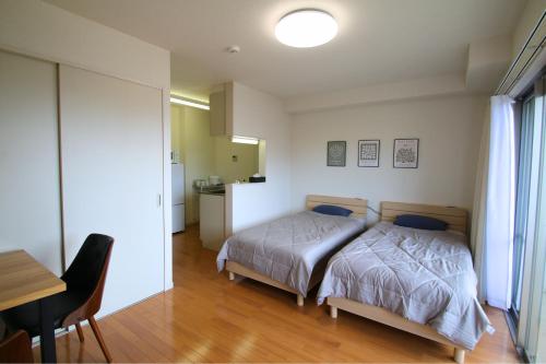 Giường trong phòng chung tại オンブラージュ704号室