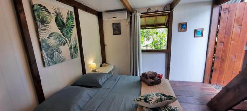 a bedroom with a bed in a room with a window at Fare Moana - Lagoon View and Serenity in Rangiroa in Avatoru