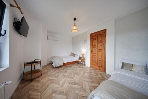 a bedroom with two beds and a wooden door at Villa High Point in Pravets