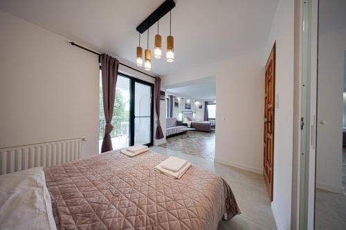 a bedroom with a bed with two towels on it at Villa High Point in Pravets
