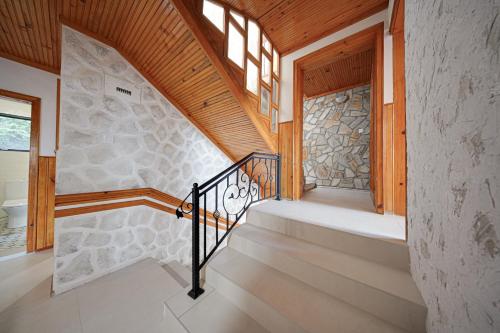 a staircase in a house with a stone wall at Villa High Point in Pravets