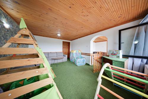 a room with a play room with a wooden ceiling at Villa High Point in Pravets