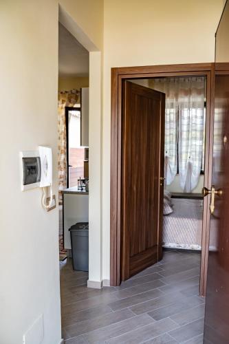 a room with a door open to a kitchen at Casa Di Amelia in Pompei