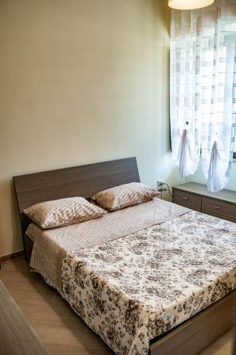 a bedroom with two beds and a window at Casa Di Amelia in Pompei