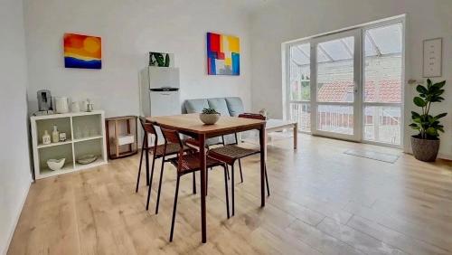 a dining room with a table and chairs in a room at Station 82A Charleroi-airport in Charleroi