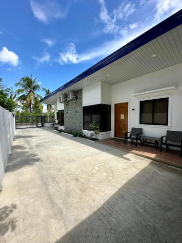 a patio of a house with a blue roof at Fully Airconditioned 2 Bedroom Unit Panglao Island in Dauis