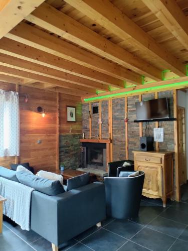 a living room with a couch and a fireplace at Gite de Champ Chaulier in Crots