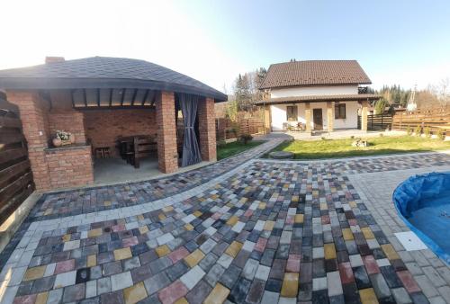 a backyard with a pool and a house at Котедж VIKTORIA in Migovo