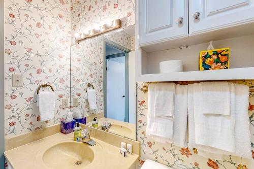 a bathroom with a sink and a mirror at Lakefront Townhouse with Lake, Pool & Tennis in Red Oak