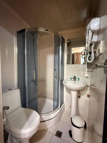 a bathroom with a shower and a toilet and a sink at Boutique Hotel Gold Tbilisi in Tbilisi City