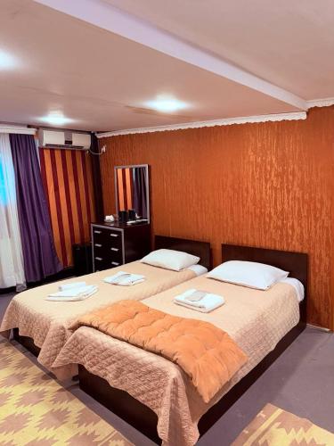 two beds in a hotel room with towels on them at Boutique Hotel Gold Tbilisi in Tbilisi City
