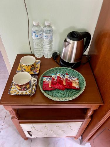 a table with a plate of food and drinks on it at PhimHomeStayCR in Ban Thung Ngio