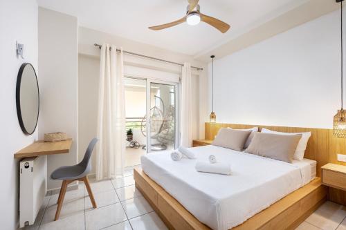 a bedroom with a white bed and a chair at Veliero Blu - Kos Marina in Ampavris
