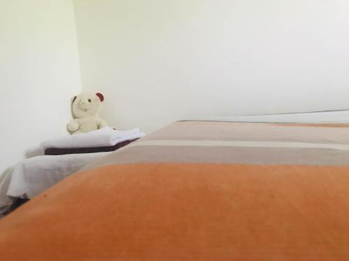 a teddy bear sitting on top of a bed at House in Koggala in Koggala