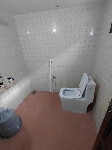 a bathroom with a toilet and a sink at VILLA DE VALENTIN home stay in Puducherry