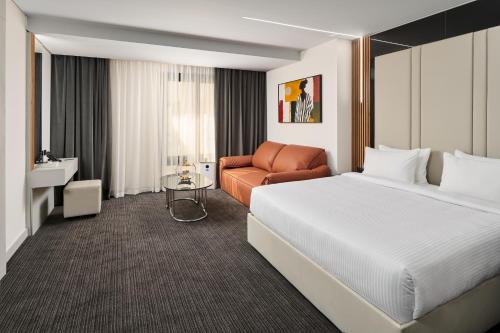 Un ou plusieurs lits dans un hébergement de l'établissement Triumph Luxury Hotel