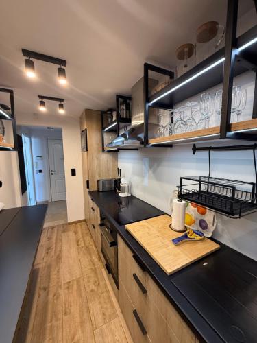 a kitchen with black counter tops and wooden cabinets at Puerto Duquesa fancy condo overlooking Marina in Manilva
