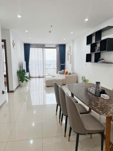 a dining room and living room with a table and chairs at Rio House district 10 Saigon Centrosa in Ho Chi Minh City